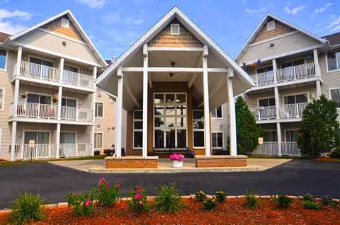 Aria at Mitchell Manor front entrance of a multi-story senior living building with balconies.