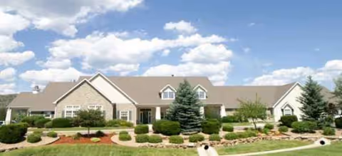 Front exterior of a Brookdale Littleton senior living facility with well-kept landscaping.
