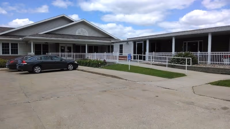 Exterior view of Griswold Rehabilitation & Health Care Center with cars and ramp