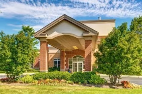 Front entrance of Montclair Senior Living & Memory Care with brick columns and landscaping