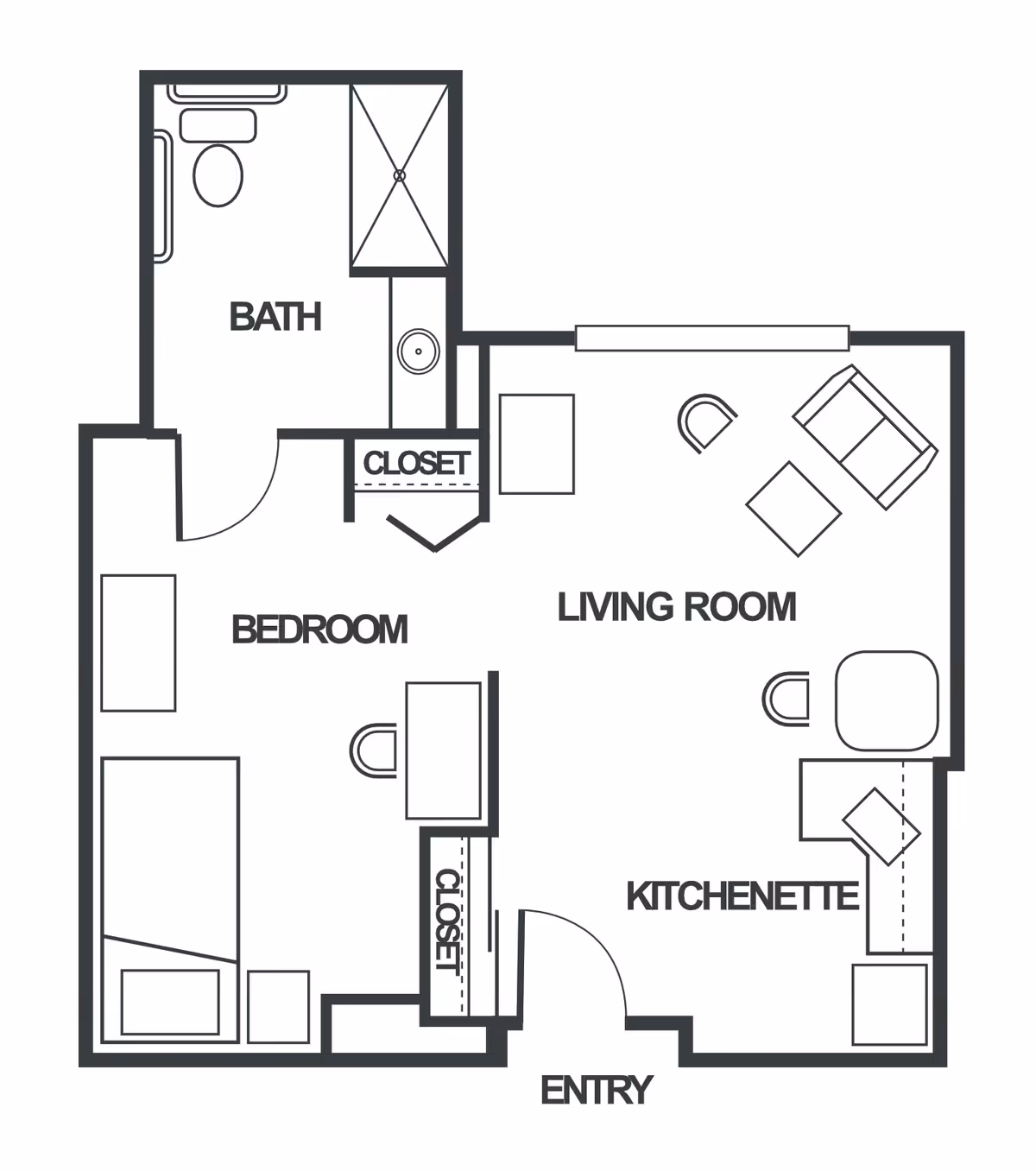 Floor plan of a senior living unit at Truewood by Merrill, First Hill, showing a bedroom with a bed and desk, a bathroom with a toilet and shower, a living room with seating furniture, and a kitchenette near the entry. Two closets are also indicated.