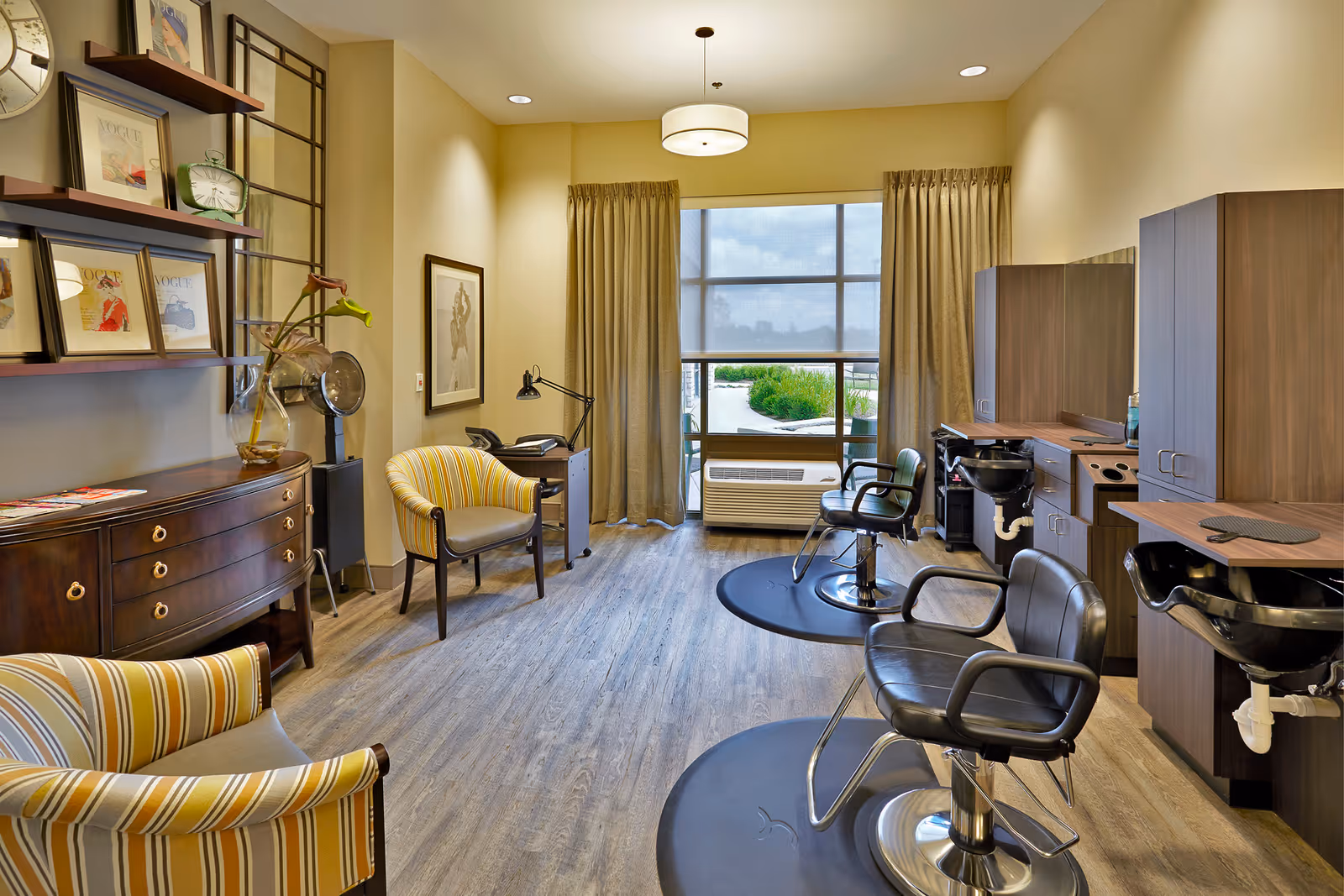 Bright interior salon with styling chairs, wash stations, seating, and cabinetry.