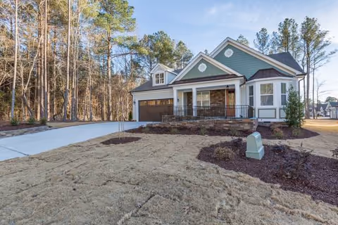 Front exterior of Avendelle Assisted Living at Heritage, a home-like building with a driveway.