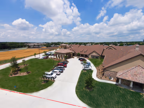 Aerial view of Belterra Health and Rehabilitation Center exterior with parking and curved driveway.