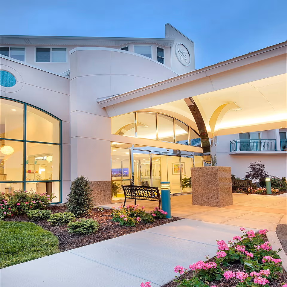 Chesterfield Villas exterior entrance with landscaped courtyard and glass doors.