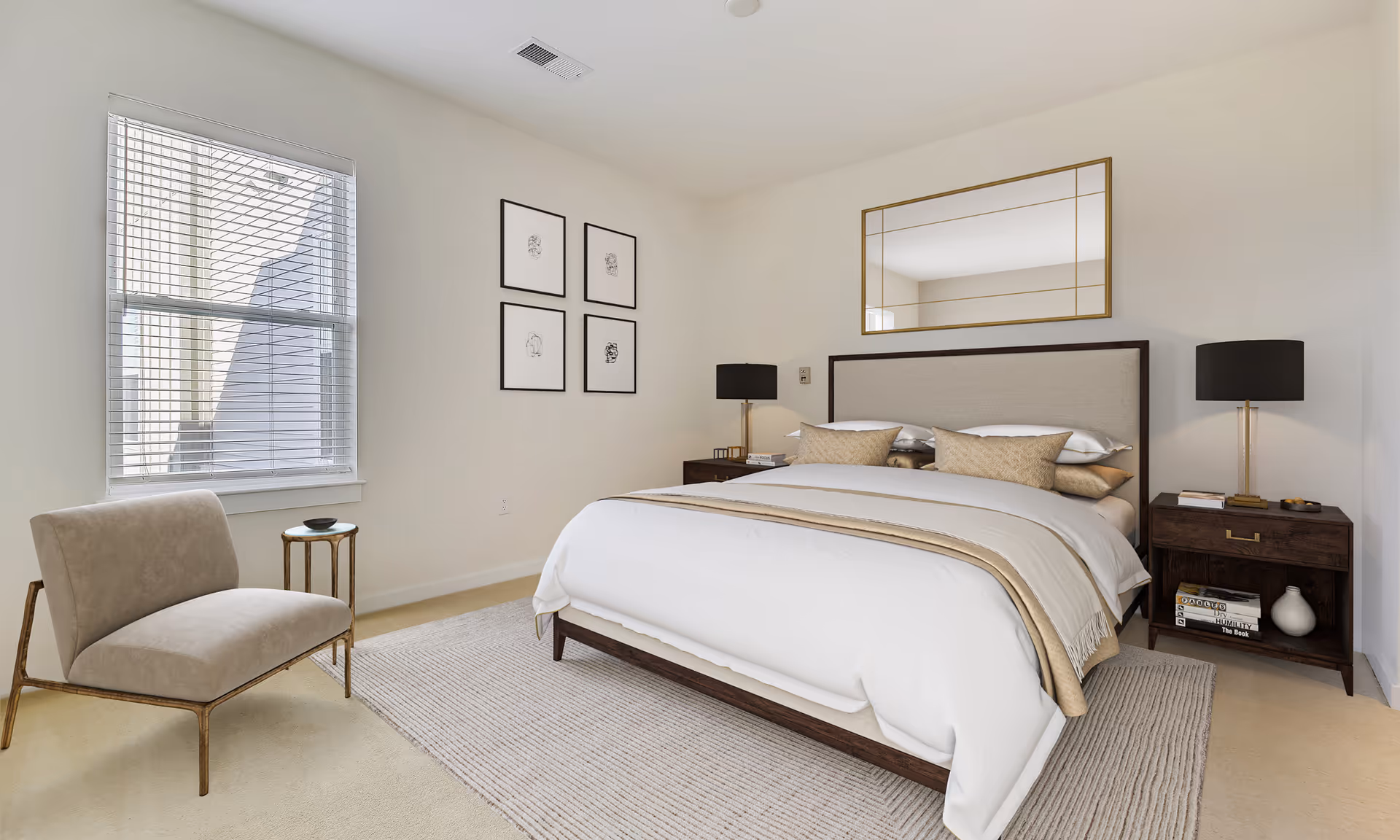 Bright, minimalist bedroom featuring a made bed with pillows, two nightstands with lamps, a chair by a window and framed wall art.