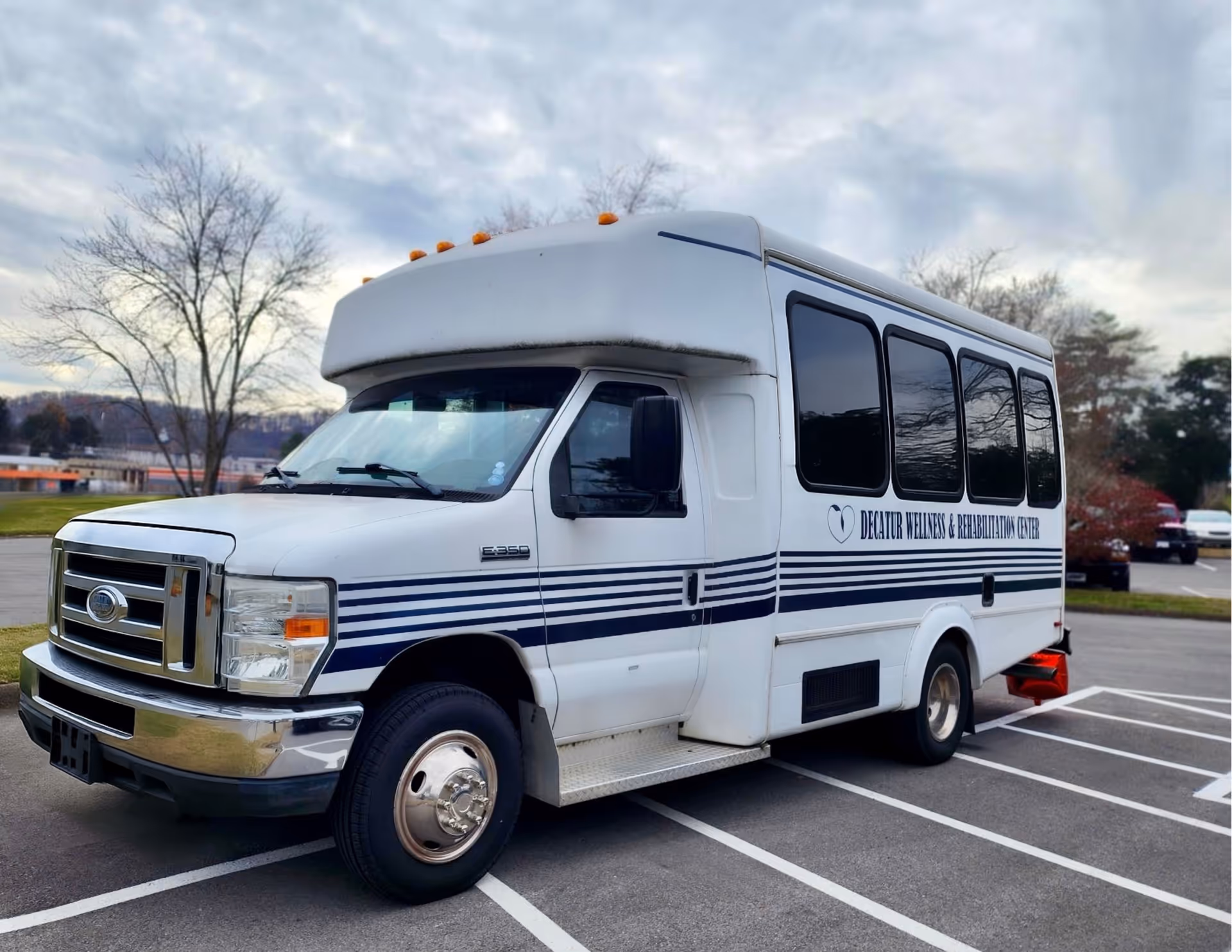 A shuttle bus parked outside the Decatur Wellness & Rehabilitation Center.