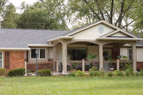 Front view of Briar Hill Assisted Living building with covered porch and green lawn