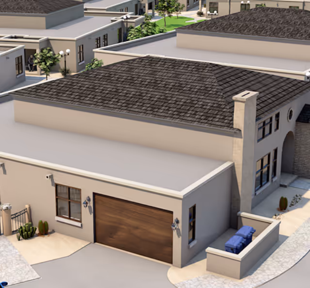 Exterior view of Hacienda Del Rey, beige building with brown garage door and walkway.