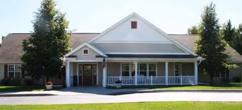 Front view of Americana Seniors of Davison building with porch and landscaping