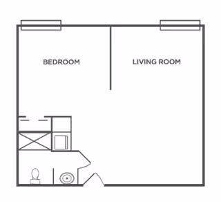 A simple architectural floor plan showing a layout with a bedroom, living room, and a small bathroom area including a toilet and sink.