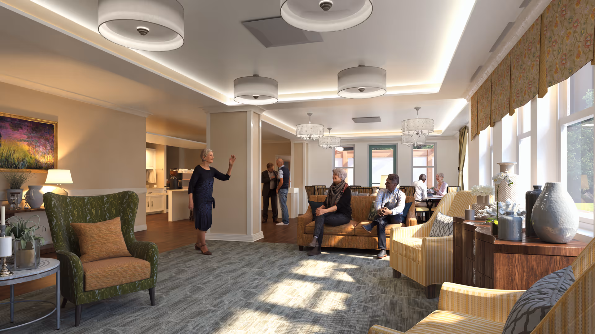 A bright and spacious senior living common area with large windows letting in natural light. Several seniors are seated on comfortable sofas and armchairs, engaging in conversation. The room features modern ceiling lights, a patterned carpet, and decorative vases on wooden furniture near the windows. In the background, a few more seniors are standing and talking near a kitchen or dining area.