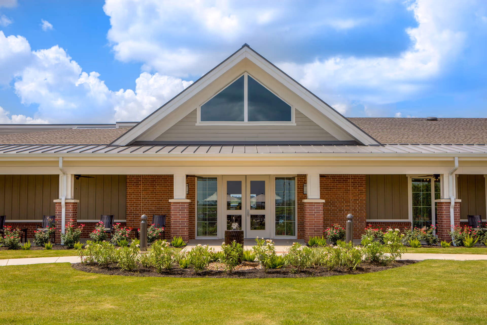 Front view of Delaney Parkway Lakes, showing a brick exterior, glass doors, and landscaped entrance.