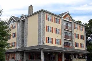 Exterior view of Chelsea Senior Living Corporate Office, a multi-story building with balconies.