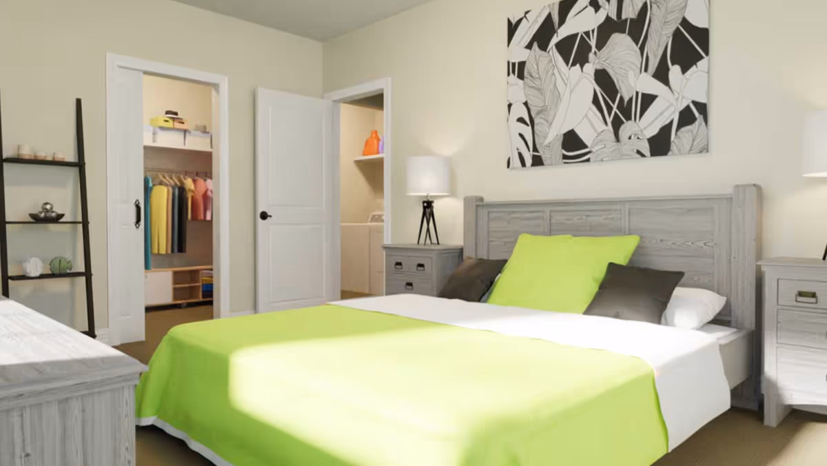 A bedroom with a wooden bed frame and matching nightstands. The bed is made with a bright green blanket and pillows, along with darker accent pillows. There is a black and white botanical artwork hanging above the bed. To the left, there is an open door revealing a closet with colorful clothes hanging and another door leading to a laundry area with a washing machine and detergent bottles. A black ladder-style shelf with decorative items is also visible.