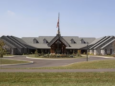 Front exterior view of Heritage Senior Living of Marysville with flag and driveway