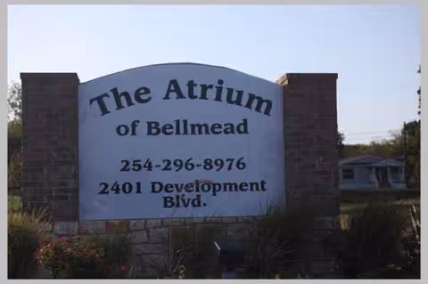 The Atrium of Bellmead entrance sign on a stone structure at the front.