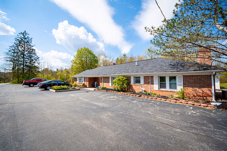 Exterior view of Amelia Grace Assisted Living facility showing brick structure and landscaping.