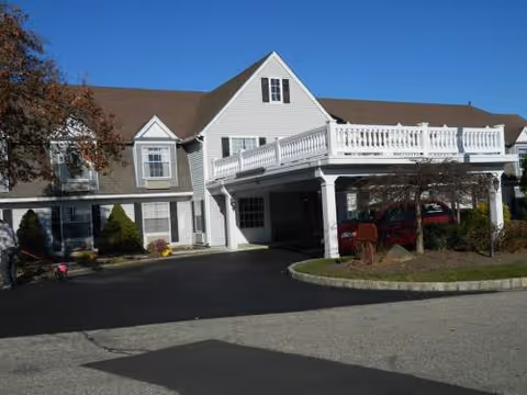 Colonial Manor at Panther Valley exterior with a white two-story building and a wraparound deck.