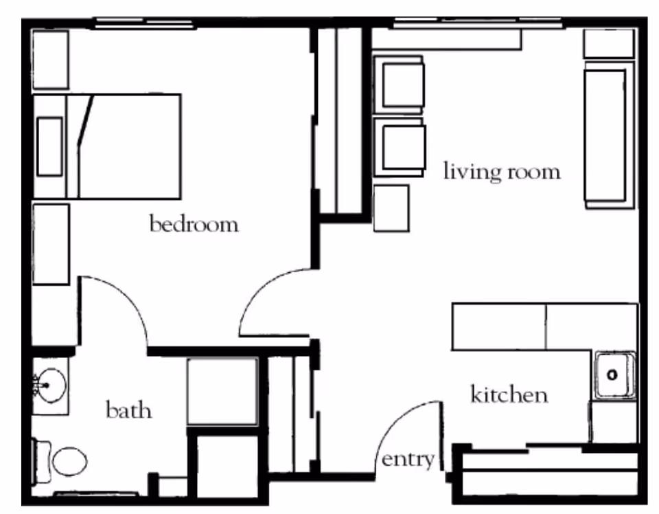Floor plan of a one-bedroom apartment showing a bedroom with a bed and two side tables, a bathroom with a toilet and sink, a living room with seating furniture, and a kitchen with a sink and counter space. The entry door opens into the kitchen area.