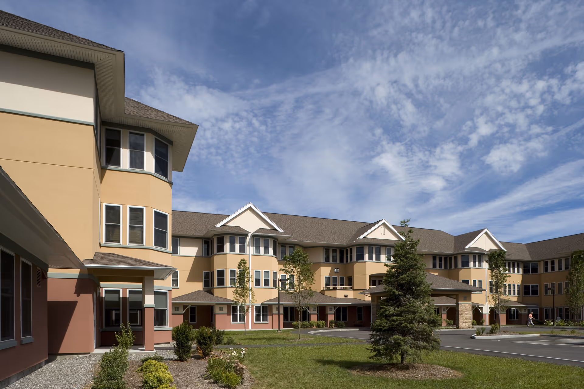 Exterior view of Taylor Community building with tan walls, windows, and lawn.