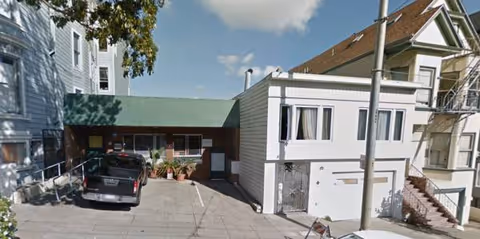 Exterior view of Care and Care Residence I with parking area and entrance.