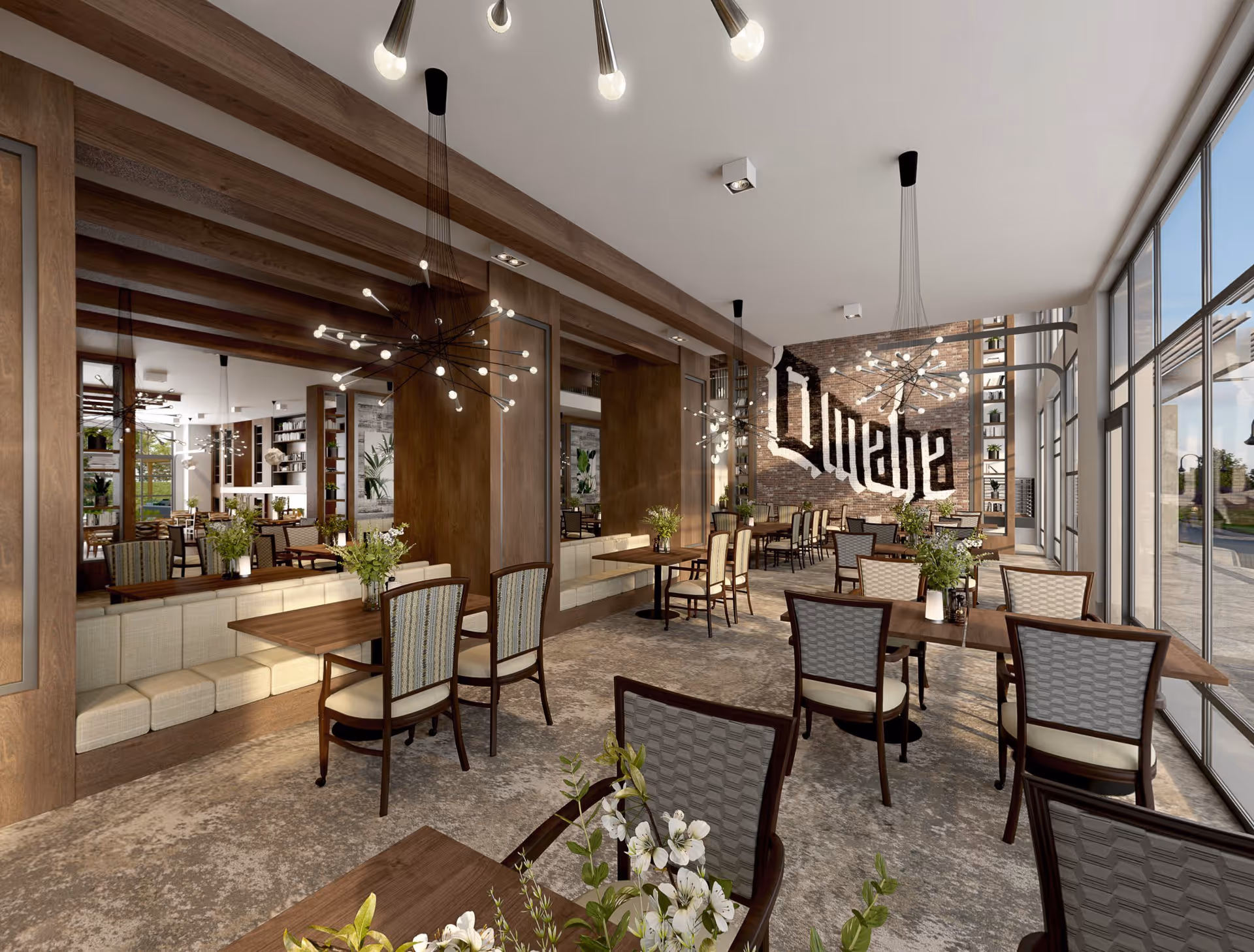 A spacious dining room with multiple wooden tables and cushioned chairs arranged neatly. The room features large floor-to-ceiling windows on one side allowing natural light to fill the space. Modern light fixtures hang from the ceiling, and there are decorative plants on the tables. A brick wall at the far end displays the word 'Ovation' in large stylized letters. The interior design includes wooden beams and paneling, creating a warm and inviting atmosphere.