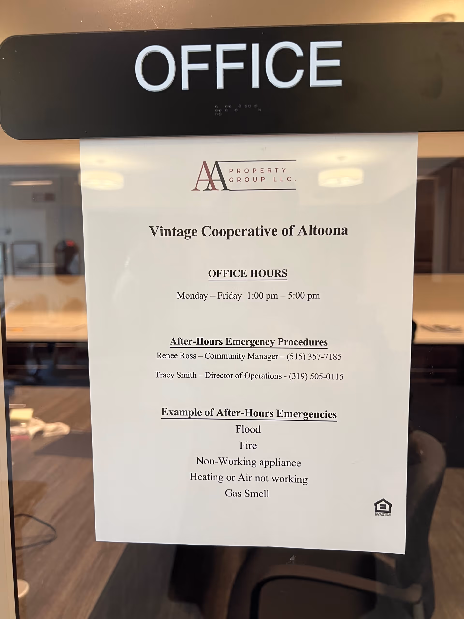 Glass office door labeled 'OFFICE' with a posted office hours and emergency procedures notice for Vintage Cooperative of Altoona.
