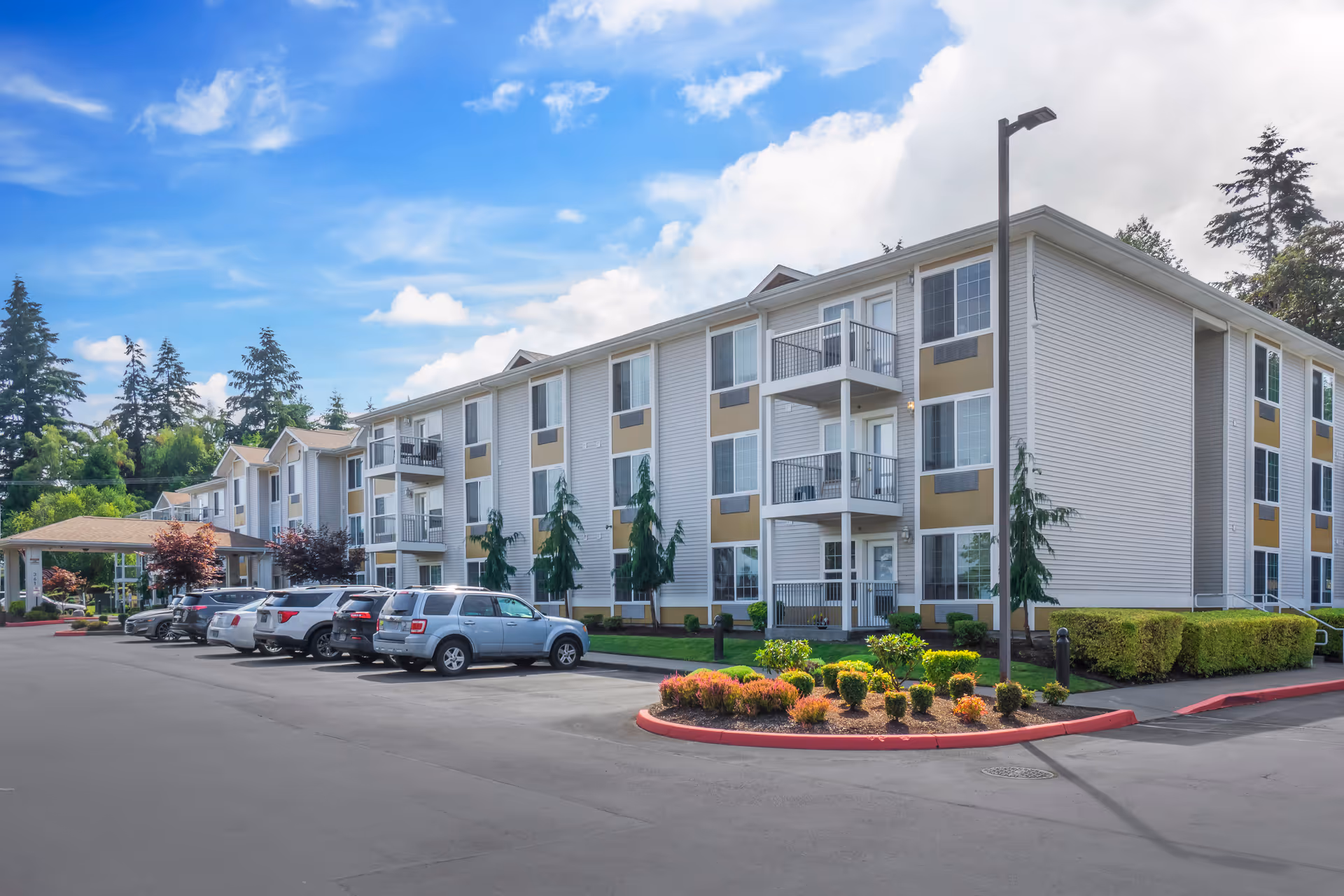 Exterior view of a Brookdale Allenmore multi-story senior living building with a parking lot.