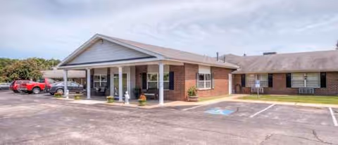 Louisburg Healthcare and Rehabilitation Center exterior with a covered entrance and parking lot