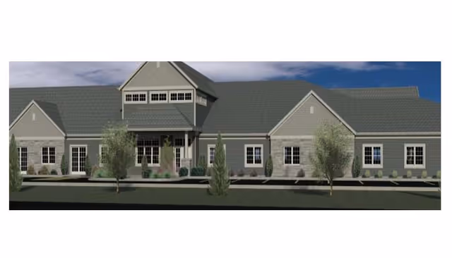 Single-story senior living facility exterior with a central entrance and manicured landscaping.