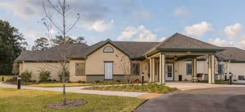 Exterior view of a Brookdale Chambrel Pinecastle senior living facility with a covered entrance.