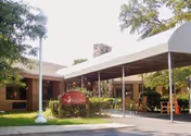 Exterior of Arbor Ridge at Brookmeade with a covered outdoor seating area.