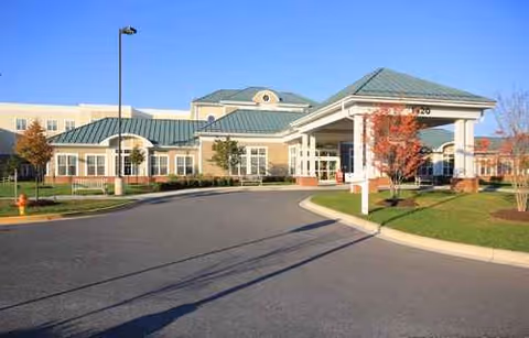 Exterior view of a senior care center with a covered entrance.