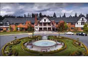 Front view of Franke Tobey Jones Retirement Estates featuring a circular fountain and landscaped roundabout.