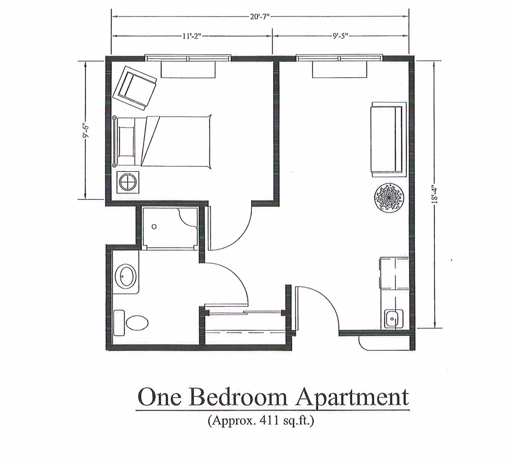 Floor plan of a one bedroom apartment approximately 411 square feet, showing a bedroom with a bed and chair, a bathroom with a toilet and shower, and a living area with a sofa, table, and kitchenette.