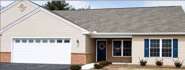 Front exterior of Mount Joy Country Homes building with garage and entrance.