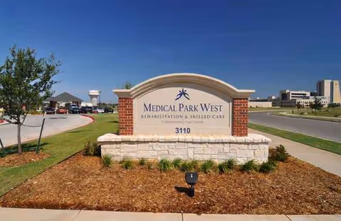 Curved brick sign reads Medical Park West Rehabilitation and Skilled Care at entrance.