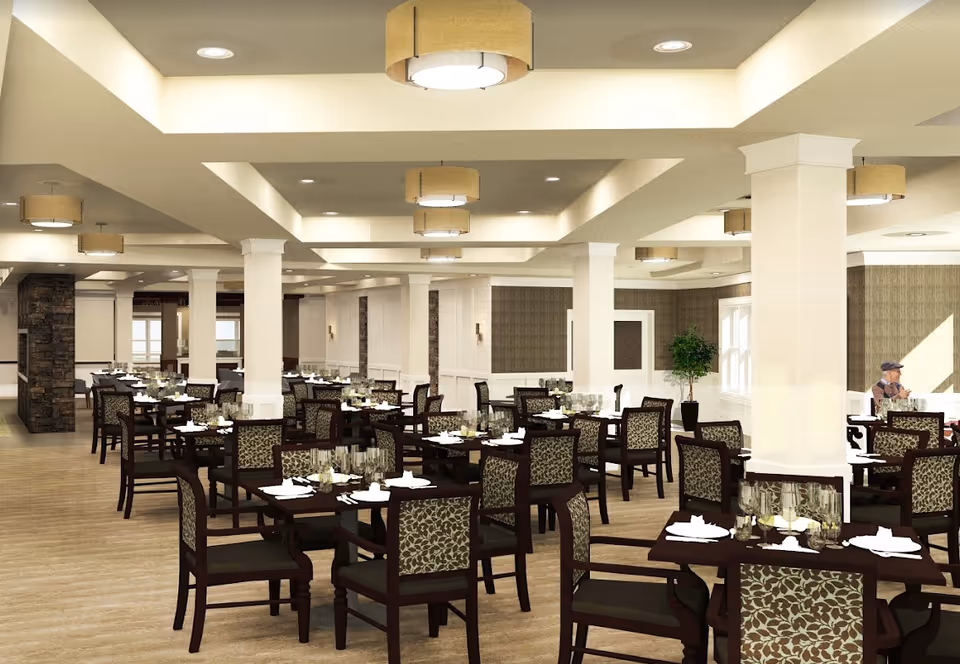 Spacious dining room with multiple set tables and patterned chairs beneath recessed ceilings and pendant lights.