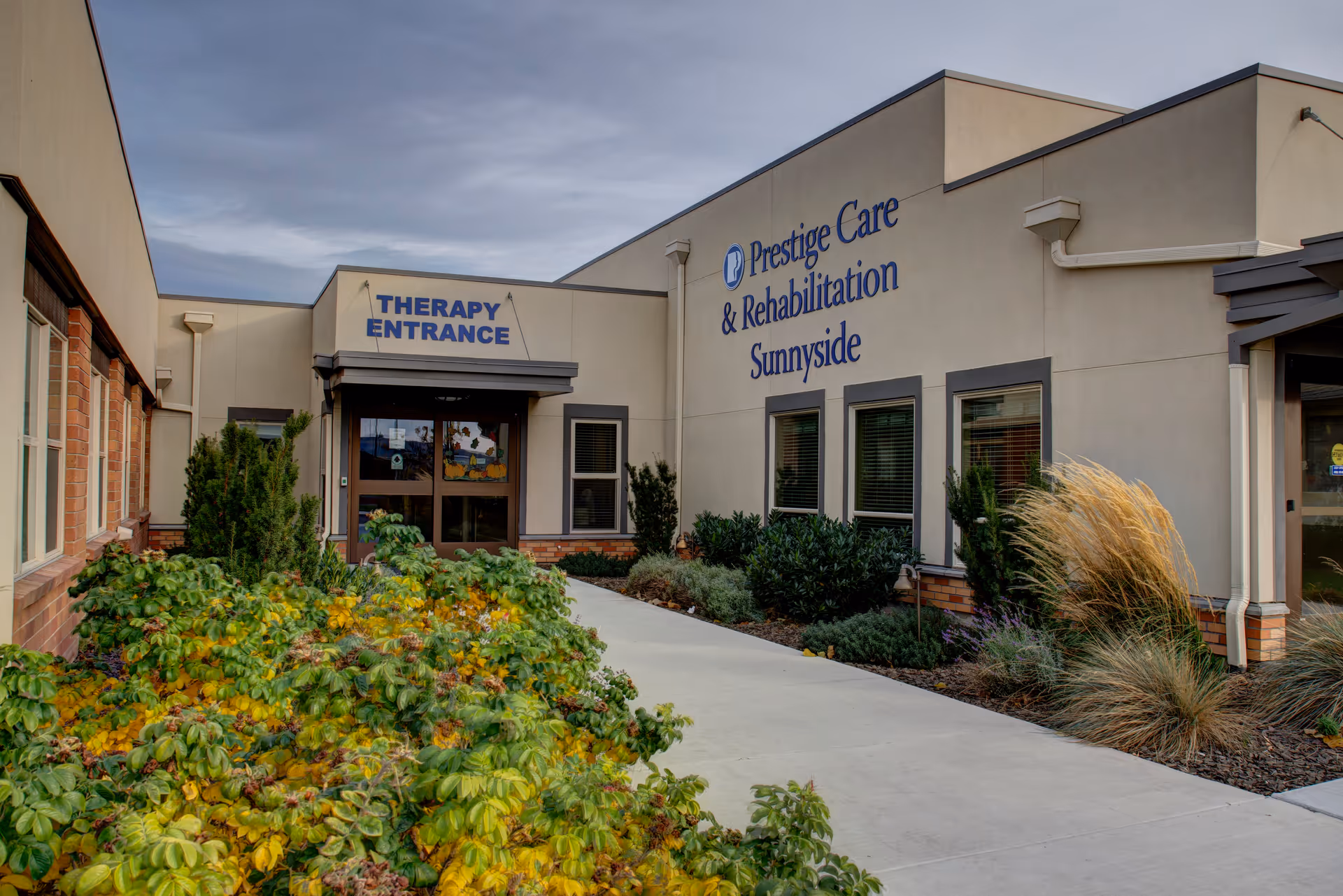 Exterior view of the Sunnyside Healthcare Center featuring the therapy entrance.