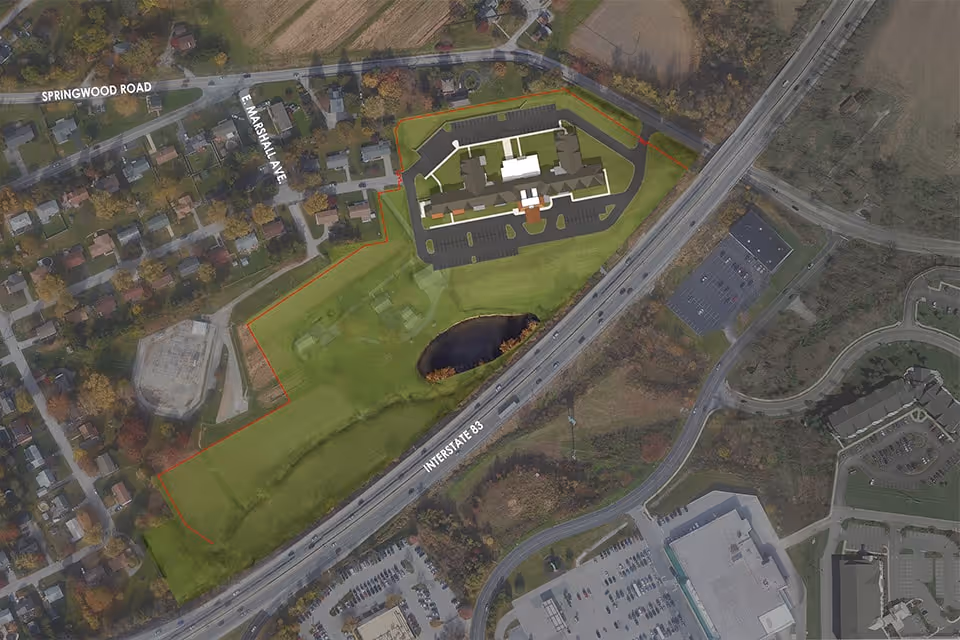 Aerial view of a residential area with a highlighted site plan for The Residence at Fitz Farm, showing building layout, parking lots, surrounding roads including Interstate 83, Springwood Road, and E Marshall Ave, and nearby houses and green spaces.