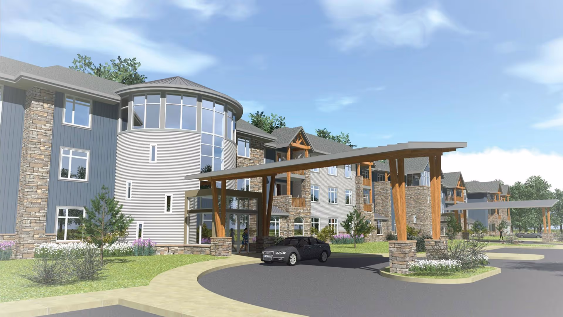 Exterior view of a modern three-story senior living facility with stone and wood accents, large windows, and covered entrance drive with wooden beams. A black car is parked near the entrance, and there are landscaped areas with grass, shrubs, and trees under a partly cloudy sky.