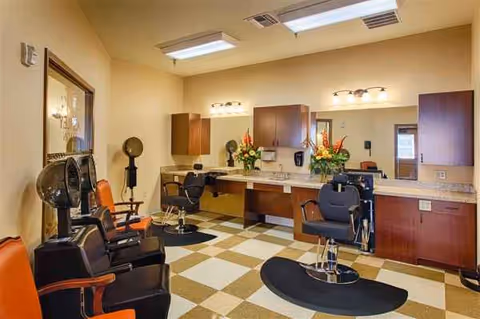 Hollymead senior living facility hair salon with mirrors, styling chairs, and counter stations.