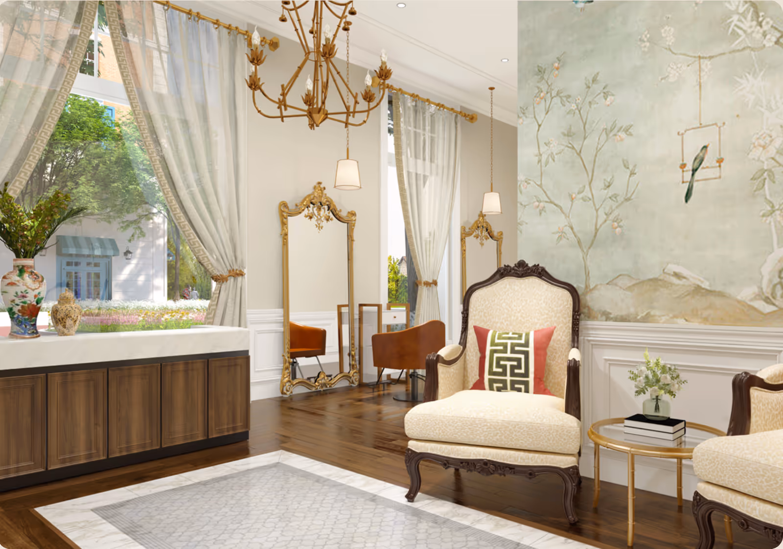 Elegant interior room with large windows draped with sheer curtains, a wooden cabinet topped with decorative vases, two ornate gold-framed mirrors, brown leather chairs, and two upholstered armchairs with patterned cushions. A small round table with books and a flower vase sits between the armchairs. The wall features a soft green mural with floral and bird designs, and a gold chandelier hangs from the ceiling.