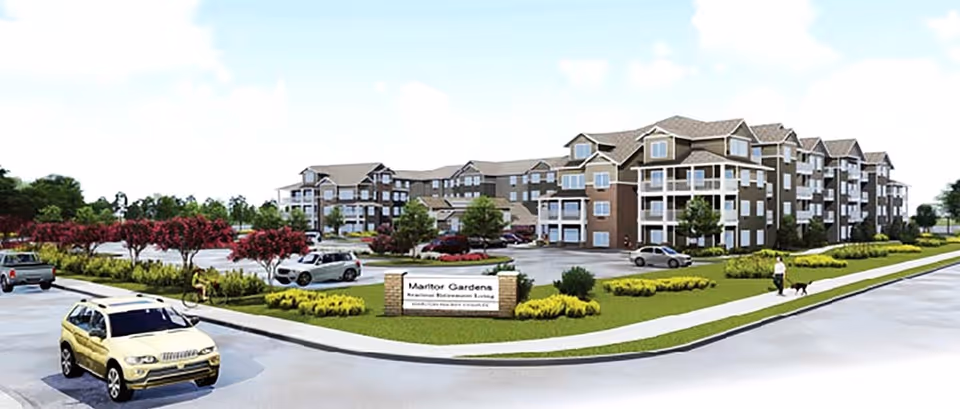 Exterior view of Marlton Gardens retirement living facility with parking and curved driveway.