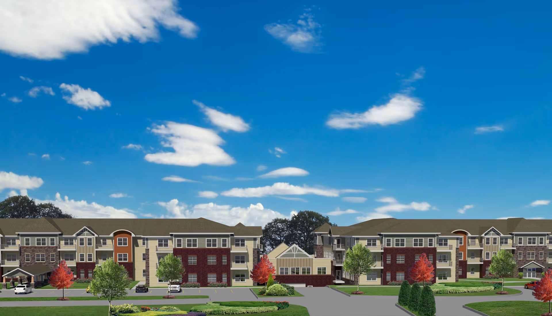 Front exterior view of a low-rise senior living complex with multiple connected buildings, landscaped lawns and a blue sky.