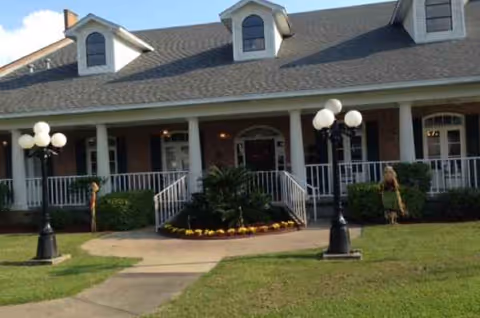 Front exterior view of a nursing and rehabilitation facility with a covered porch.