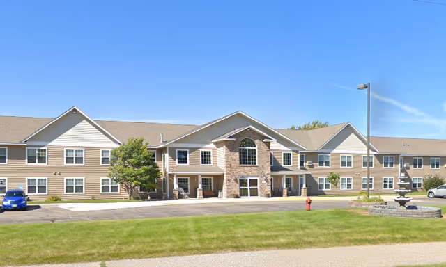 Exterior view of Vista Prairie at North Pointe, a senior living facility with landscaped entrance.