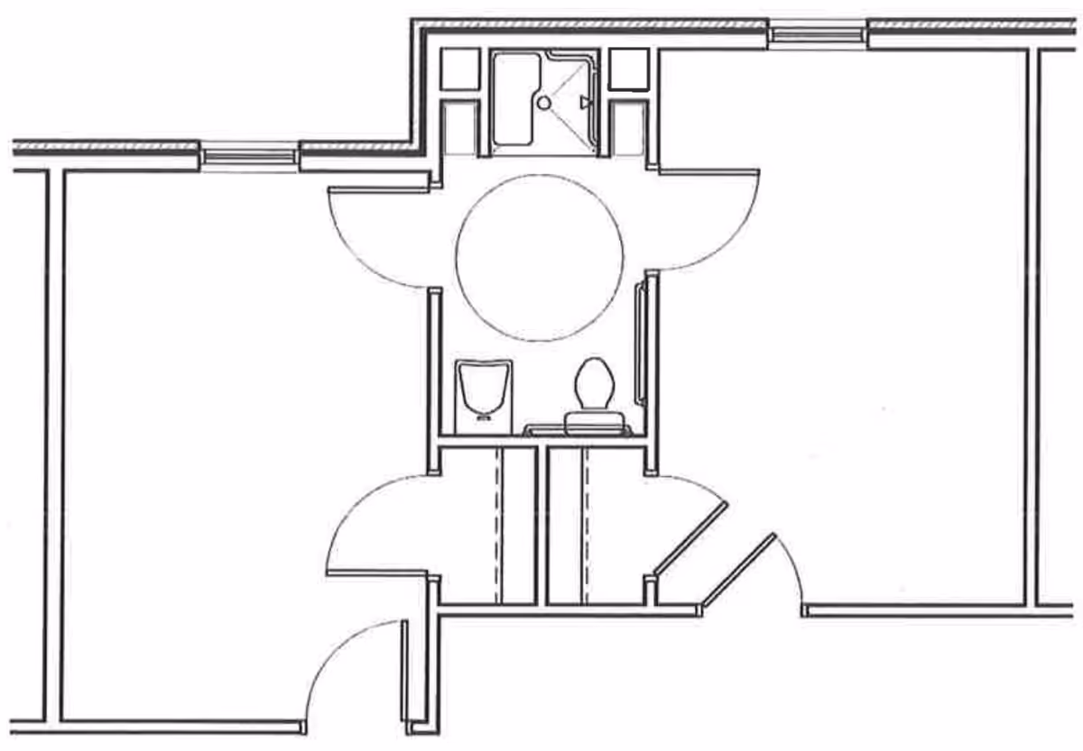 Architectural floor plan showing a layout with two rooms connected by a central bathroom area that includes a shower, toilet, and sink.