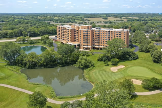 Aerial view of Brookdale Hoffman Estates showing the building, ponds, and green landscape.